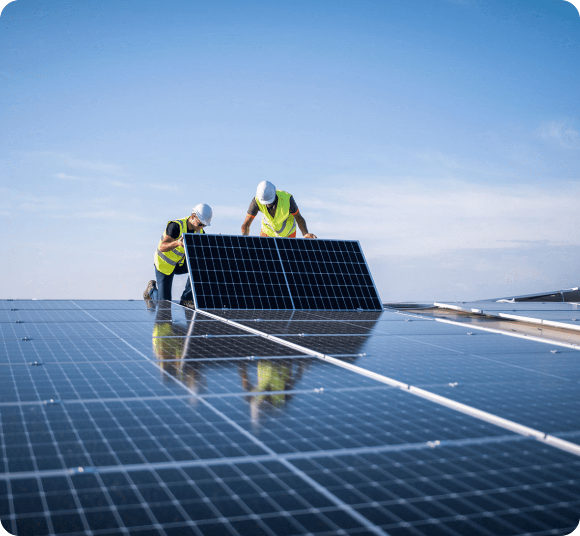 Workers installing solar panels on roof.